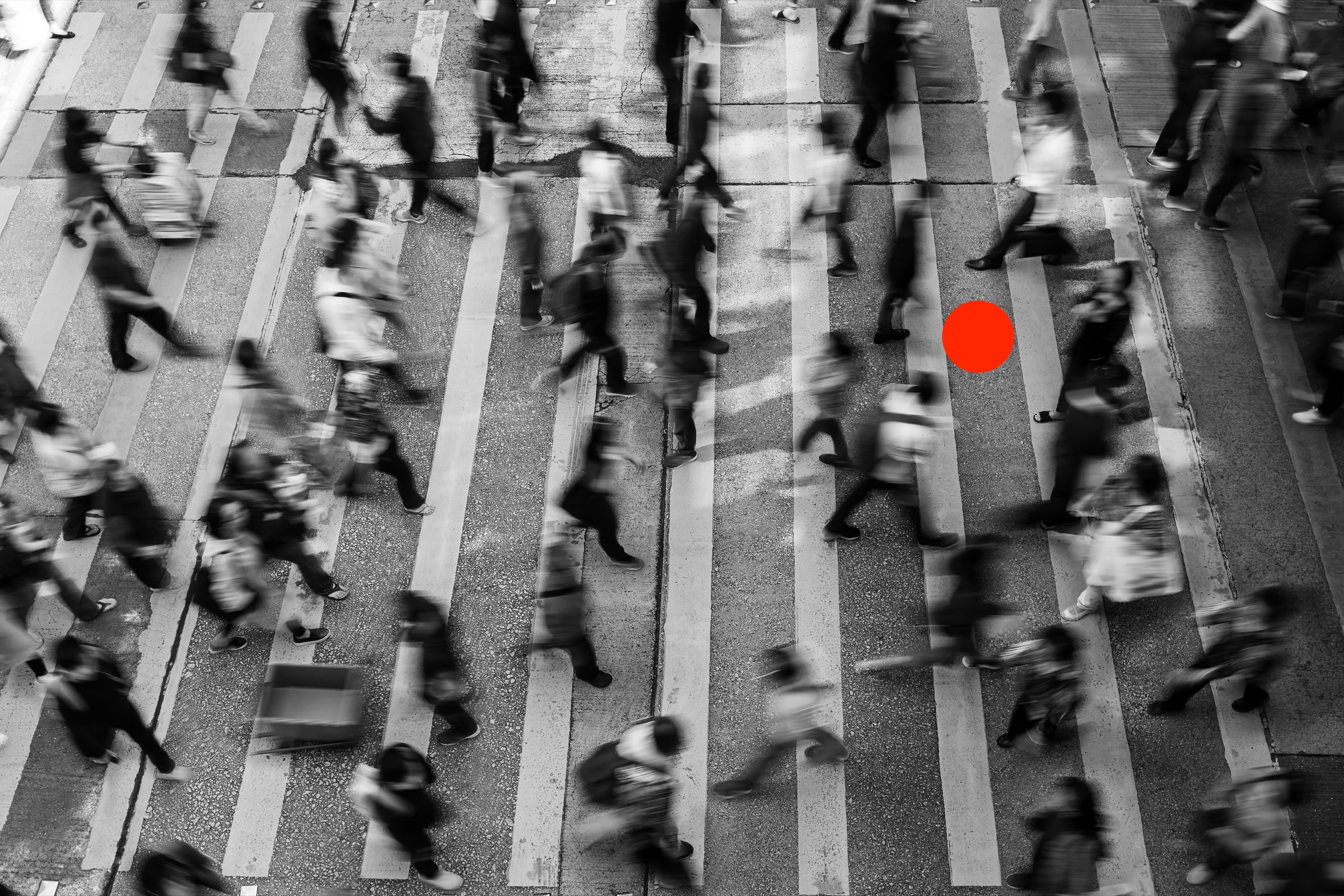 People crossing a street, with one red point highlighted